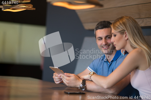 Image of couple using tablet at home