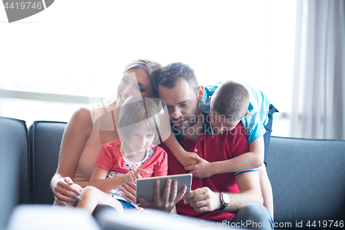 Image of happy young couple spending time with kids