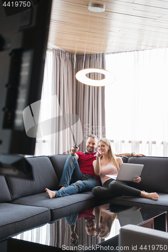 Image of happy couple relaxes in the living room