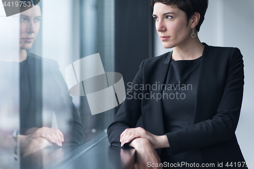 Image of Portrait of successful Businesswoman by the window