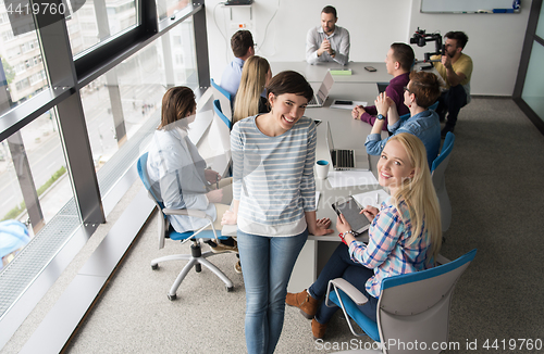 Image of Pretty Businesswomen Using Tablet In Office Building during conf