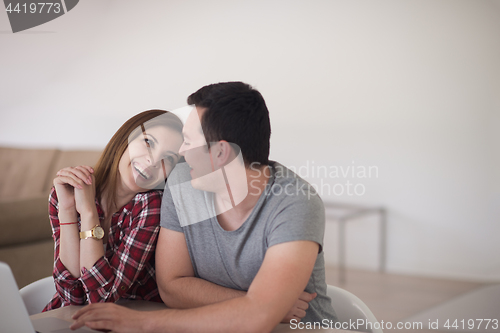 Image of happy young couple buying online