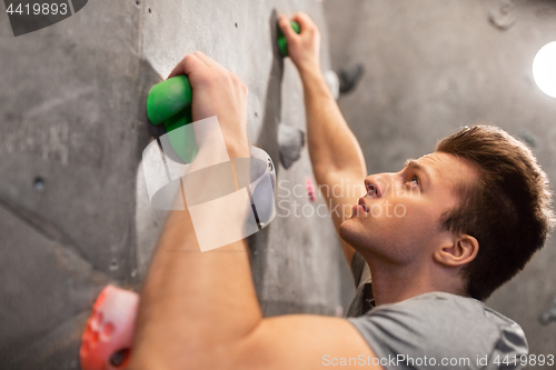 Image of young man exercising at indoor climbing gym