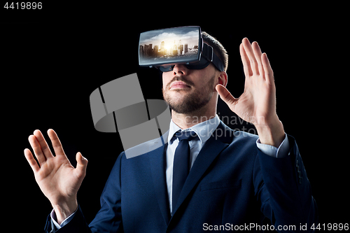 Image of businessman in virtual reality glasses or headset