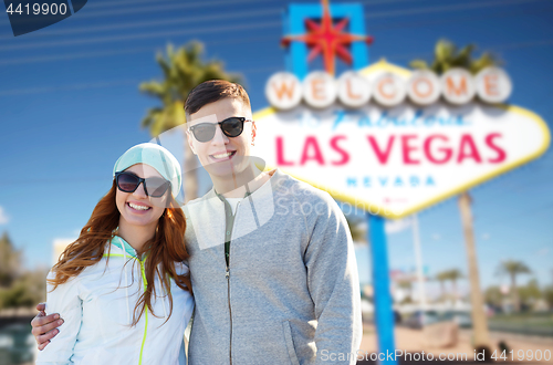 Image of teenage couple in shades over las vegas sign