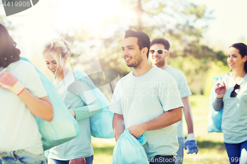 Image of group of volunteers with garbage bags in park