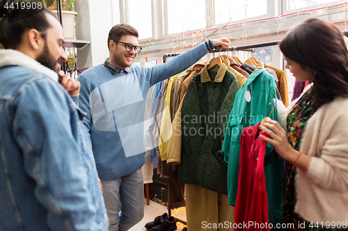 Image of friends choosing clothes at vintage clothing store