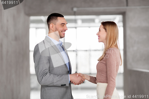 Image of smiling businesswoman and businessman at office