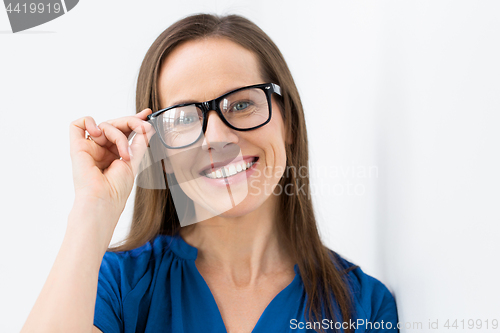 Image of close up of smiling middle aged woman in glasses