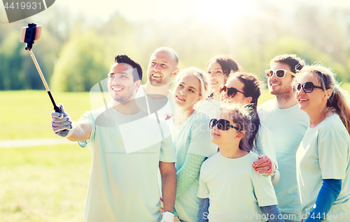 Image of group of volunteers taking smartphone selfie