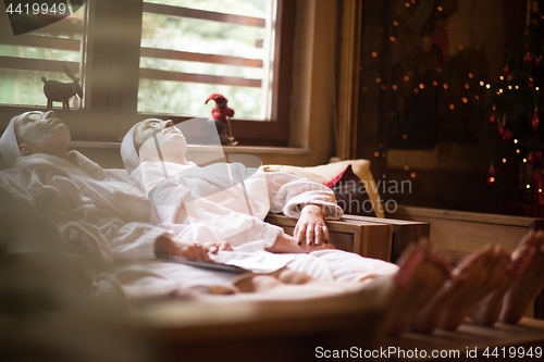 Image of women is getting facial clay mask at spa