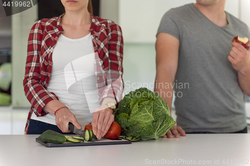 Image of Young handsome couple in the kitchen