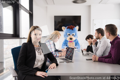 Image of boss dresed as bear having fun with business people in trendy of