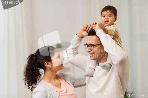 Image of happy family and baby daughter playing at home
