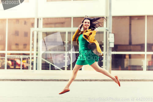 Image of smiling young woman or girl calling on smartphone