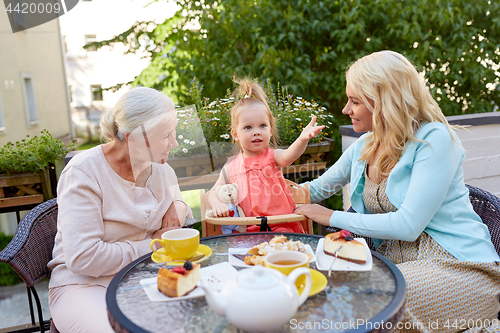 Image of mother, daughter and grandmother at cafe