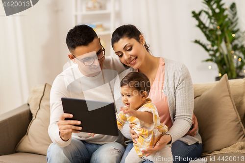 Image of mother, father and baby with tablet pc at home