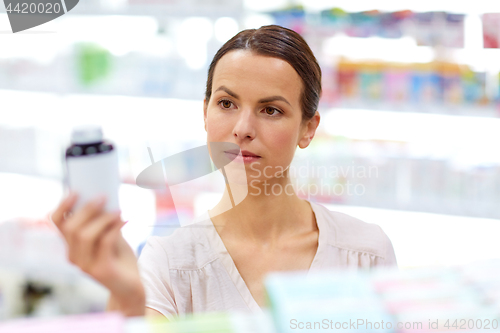 Image of female customer choosing drugs at pharmacy