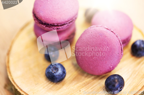 Image of blueberry macarons on wooden stand