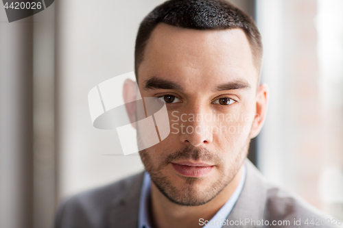 Image of portrait of businessman in suit at office