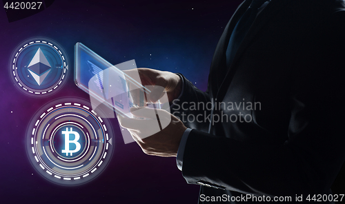 Image of businessman with tablet pc and cryptocurrency