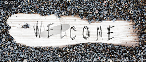 Image of Sand on planked wood - Welcome