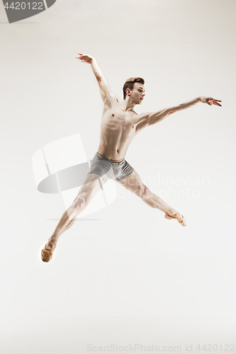 Image of The male athletic ballet dancer performing dance isolated on white background.