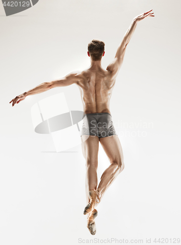 Image of The male athletic ballet dancer performing dance isolated on white background.