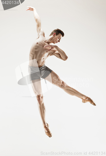 Image of The male athletic ballet dancer performing dance isolated on white background.