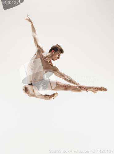 Image of The male athletic ballet dancer performing dance isolated on white background.