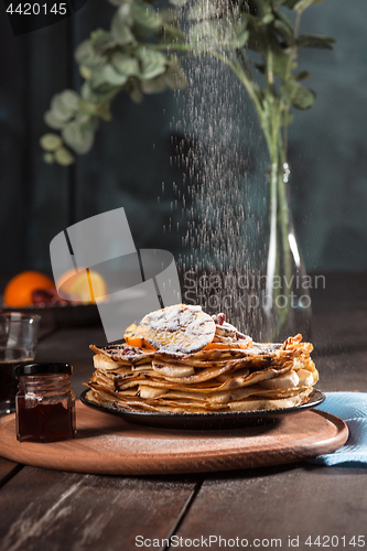 Image of Fresh homemade french crepes made with eggs, milk and flour, filled with marmalade on a vintage plate