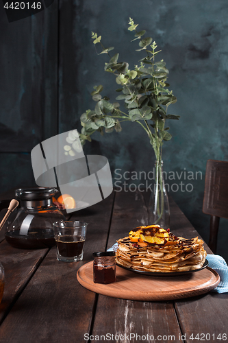 Image of Fresh homemade french crepes made with eggs, milk and flour, filled with marmalade on a vintage plate