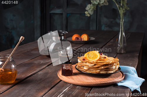 Image of Fresh homemade french crepes made with eggs, milk and flour, filled with marmalade on a vintage plate