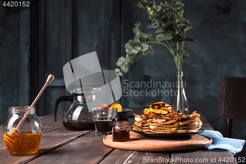 Image of Fresh homemade french crepes made with eggs, milk and flour, filled with marmalade on a vintage plate