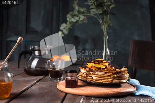 Image of Fresh homemade french crepes made with eggs, milk and flour, filled with marmalade on a vintage plate