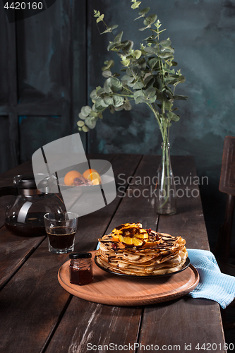 Image of Fresh homemade french crepes made with eggs, milk and flour, filled with marmalade on a vintage plate