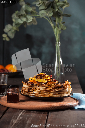 Image of Fresh homemade french crepes made with eggs, milk and flour, filled with marmalade on a vintage plate