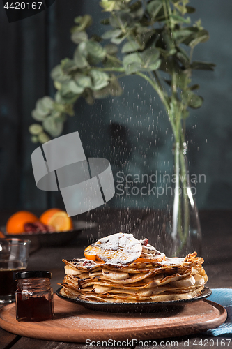 Image of Fresh homemade french crepes made with eggs, milk and flour, filled with marmalade on a vintage plate