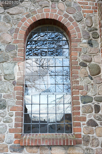 Image of Tree reflection in a window. Uggeløse church in 2017