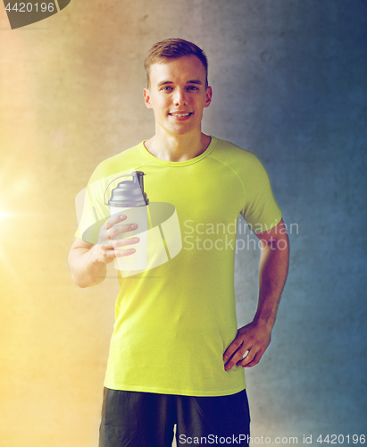 Image of smiling man with protein shake bottle