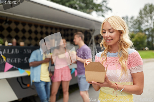 Image of happy woman with wok and friends at food truck