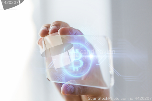 Image of close up of bitcoin on transparent smartphone