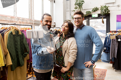 Image of friends taking selfie at vintage clothing store