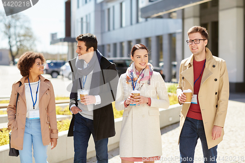 Image of office workers with coffee on city street