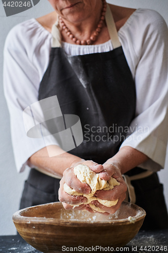 Image of Baker hands kneading dough