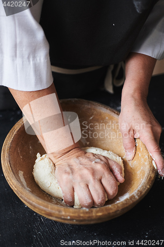 Image of Baker hands kneading dough