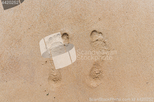 Image of Footprints in the sand. Sandy beach on a Sunny summer day.