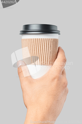 Image of Mockup of men\'s hand holding white paper large size cup with black cover