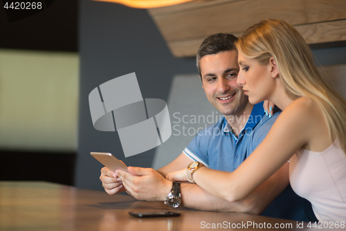 Image of couple using tablet at home