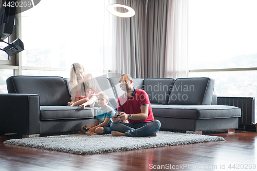 Image of Happy family playing a video game